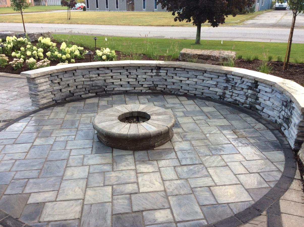 Backyard Entertaining Elements Tree Amigos Landscaping Inc Unilock Rivercrest Seat Wall Al Slate With Firepit Made From Brussels Dimensional Stone Fullnose Coping Sierra Circular Richcliff